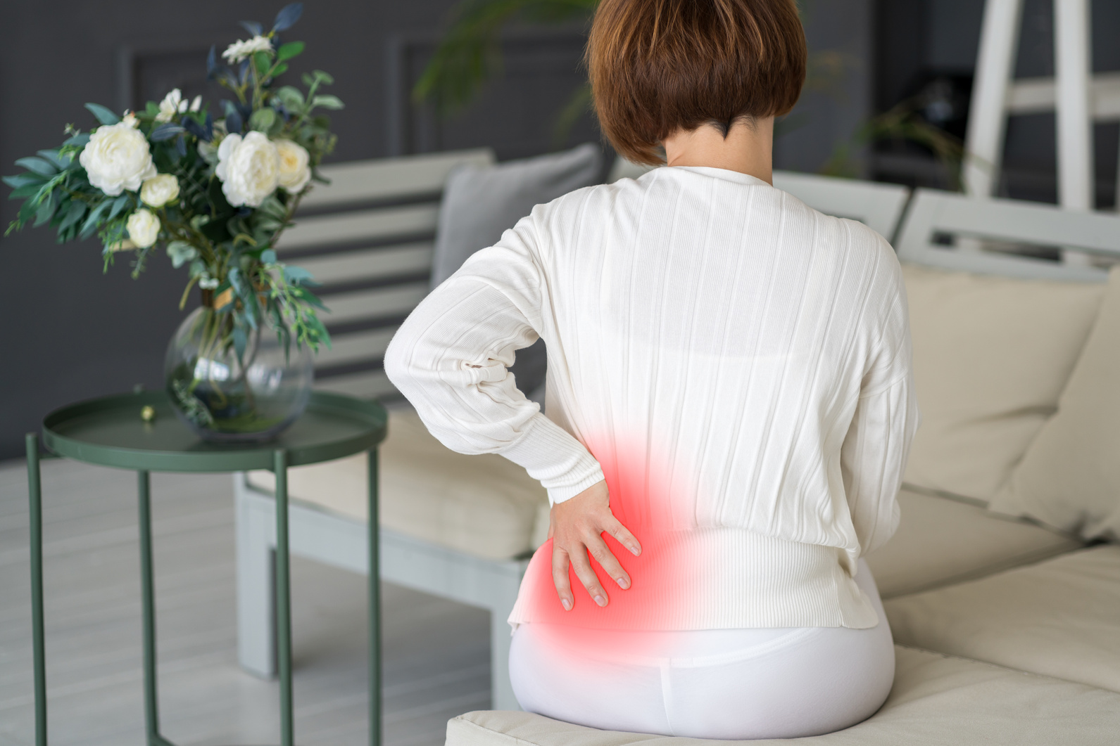 Back pain, kidney inflammation, woman suffering from backache at home